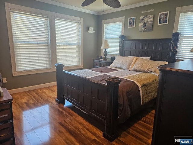 bedroom with baseboards, wood finished floors, ornamental molding, and a ceiling fan