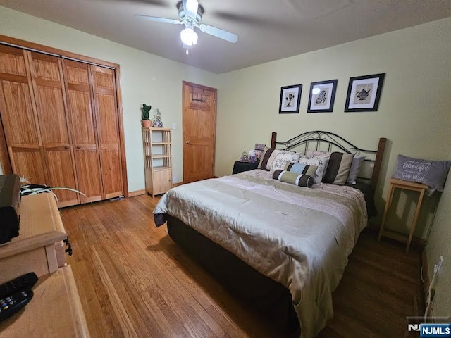 bedroom with baseboards, wood finished floors, and a ceiling fan