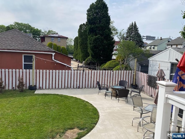 view of yard featuring a patio, fence private yard, and an outdoor fire pit