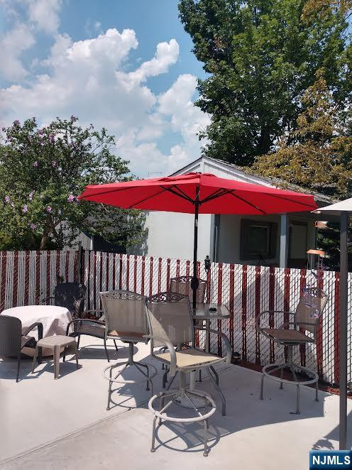 view of patio / terrace featuring fence