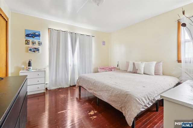 bedroom with dark wood finished floors