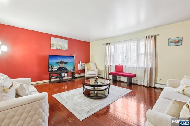 living room featuring a baseboard heating unit, wood finished floors, a wall unit AC, a baseboard radiator, and baseboards