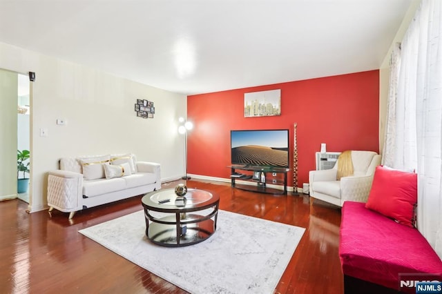 living area with baseboards and wood finished floors