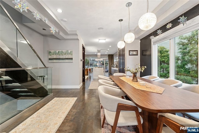 dining room featuring a raised ceiling, stairway, recessed lighting, and baseboards