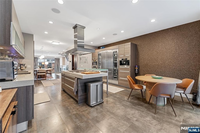 kitchen featuring a center island, light countertops, recessed lighting, island exhaust hood, and modern cabinets