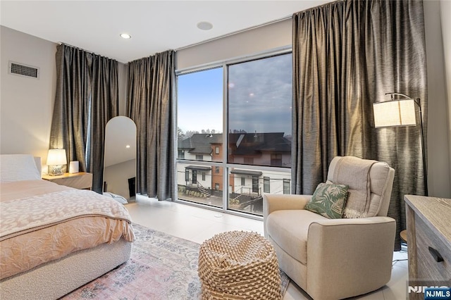 tiled bedroom with visible vents and access to outside