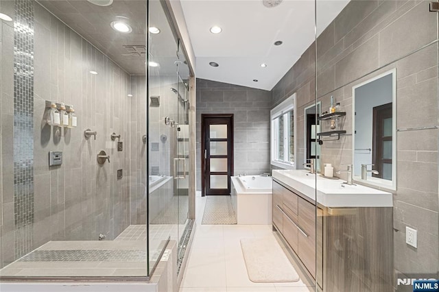 full bathroom with tile patterned floors, a stall shower, tile walls, a bath, and vanity