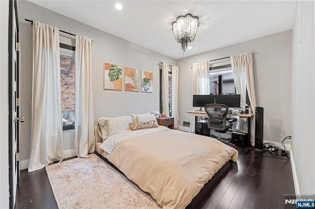 bedroom with recessed lighting, baseboards, and dark wood-type flooring