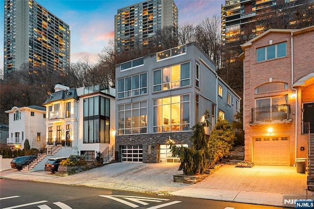 exterior space with decorative driveway and a garage