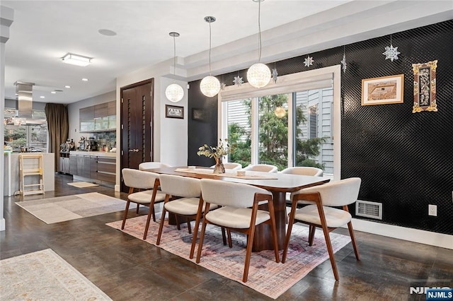 dining room featuring an accent wall, recessed lighting, baseboards, and visible vents