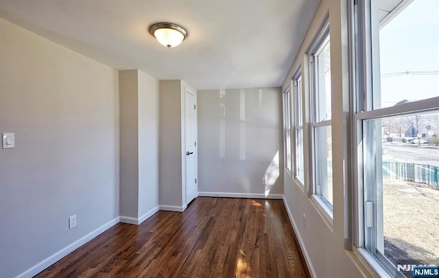 spare room with wood finished floors and baseboards