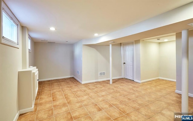 below grade area featuring recessed lighting, visible vents, baseboards, and light tile patterned floors