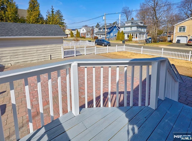 wooden deck with a residential view and fence