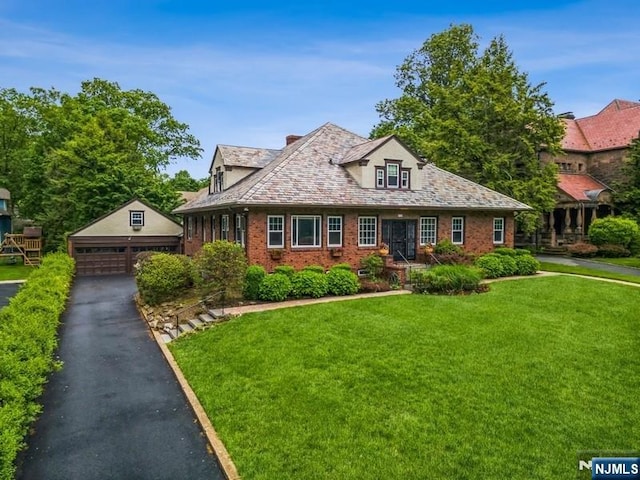 274 Ridgewood, Glen Ridge, NJ 07028 - view of front of property with an outbuilding, a detached garage, a front yard, brick siding, and a high end roof