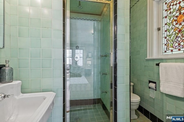 274 Ridgewood, Glen Ridge, NJ 07028 - full bathroom featuring tile walls, toilet, a shower stall, and tile patterned flooring
