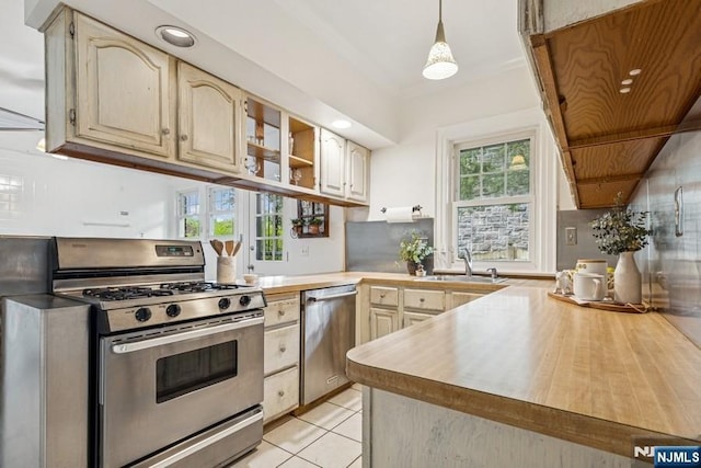 274 Ridgewood, Glen Ridge, NJ 07028 - kitchen with stainless steel appliances, a sink, light countertops, open shelves, and light tile patterned floors
