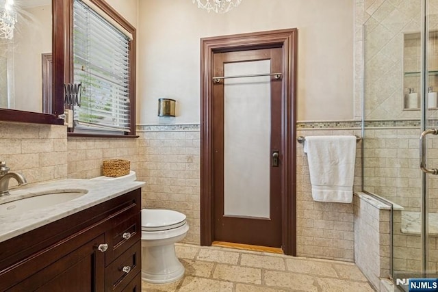 274 Ridgewood, Glen Ridge, NJ 07028 - full bathroom with tile walls, vanity, a shower stall, a wainscoted wall, and toilet