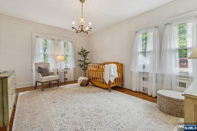 274 Ridgewood, Glen Ridge, NJ 07028 - bedroom with multiple windows, a chandelier, and wood finished floors