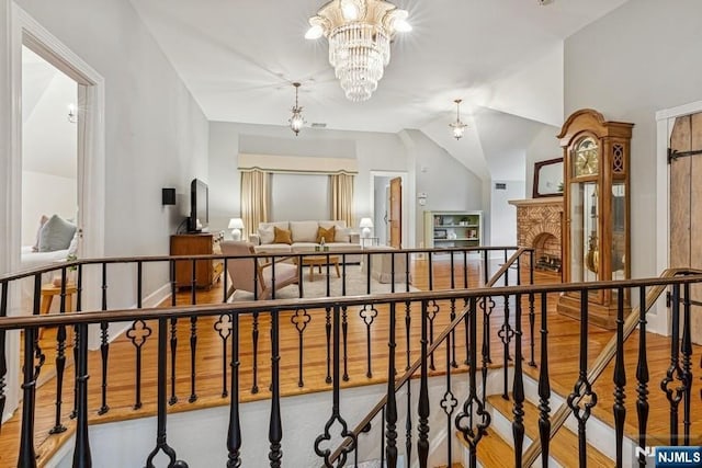 274 Ridgewood, Glen Ridge, NJ 07028 - hallway with an upstairs landing, a chandelier, wood finished floors, and vaulted ceiling