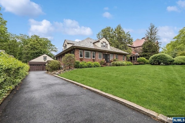 274 Ridgewood, Glen Ridge, NJ 07028 - view of front facade featuring an outbuilding, a front yard, a garage, and brick siding