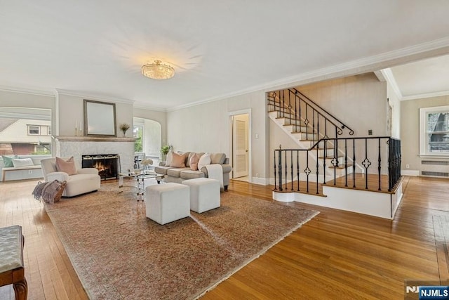 274 Ridgewood, Glen Ridge, NJ 07028 - living area with wood finished floors, a lit fireplace, stairs, ornamental molding, and arched walkways