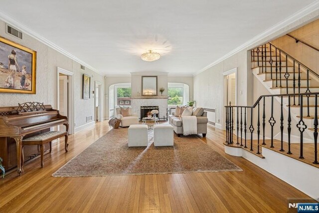 274 Ridgewood, Glen Ridge, NJ 07028 - living room with hardwood / wood-style flooring, stairway, ornamental molding, a fireplace with raised hearth, and baseboards