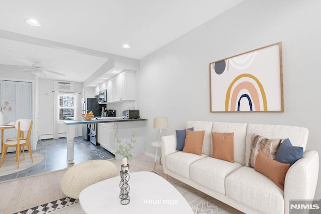 living room featuring recessed lighting, ceiling fan, and wood finished floors