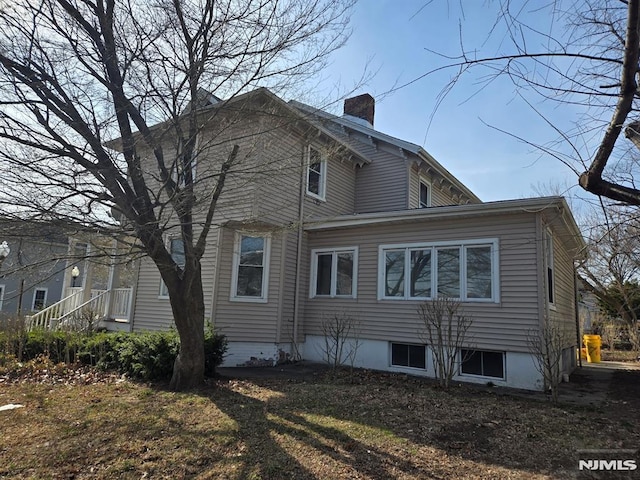 view of property exterior featuring a chimney