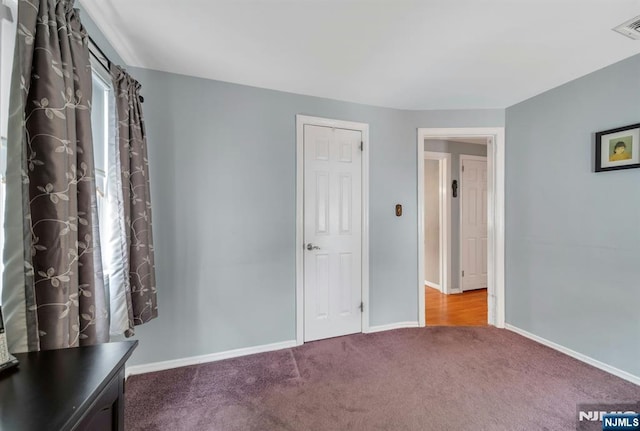 unfurnished bedroom with visible vents, baseboards, and carpet floors