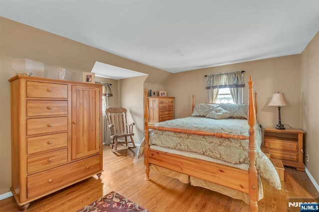 bedroom with baseboards and light wood-type flooring