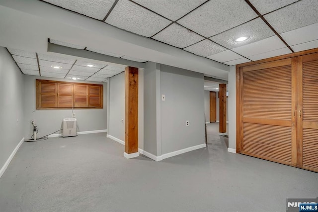 finished basement with recessed lighting, a drop ceiling, and baseboards