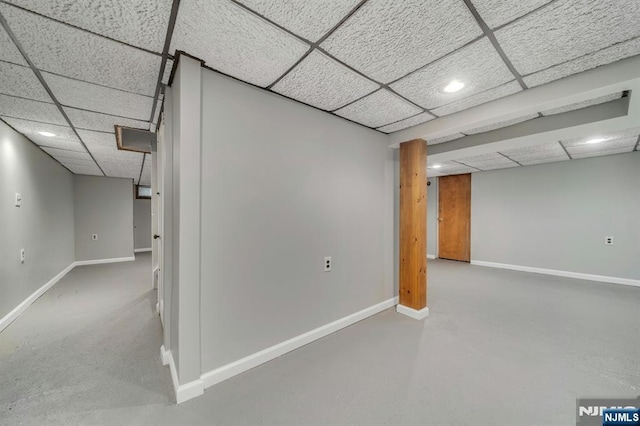 finished basement with recessed lighting, a paneled ceiling, and baseboards