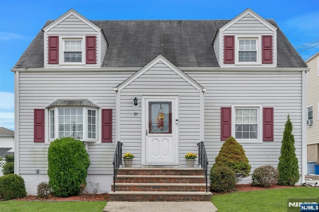 cape cod-style house featuring a front lawn