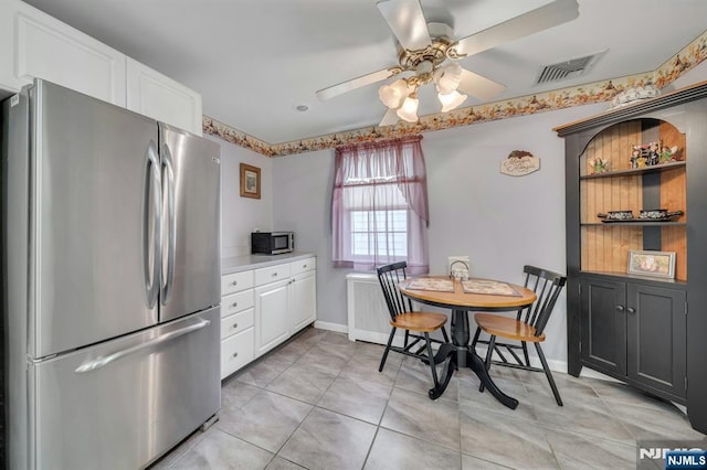 kitchen with visible vents, ceiling fan, light countertops, white cabinets, and appliances with stainless steel finishes