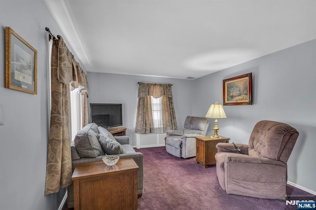 living room featuring baseboards and dark carpet