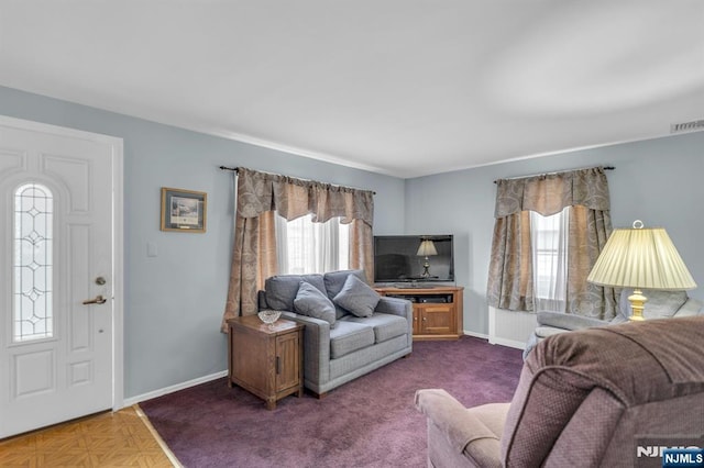 living room with visible vents and baseboards