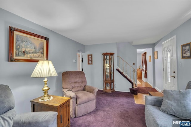 living area featuring stairs, baseboards, and carpet flooring
