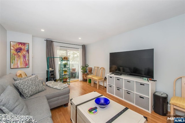 living room with recessed lighting and light wood-style floors