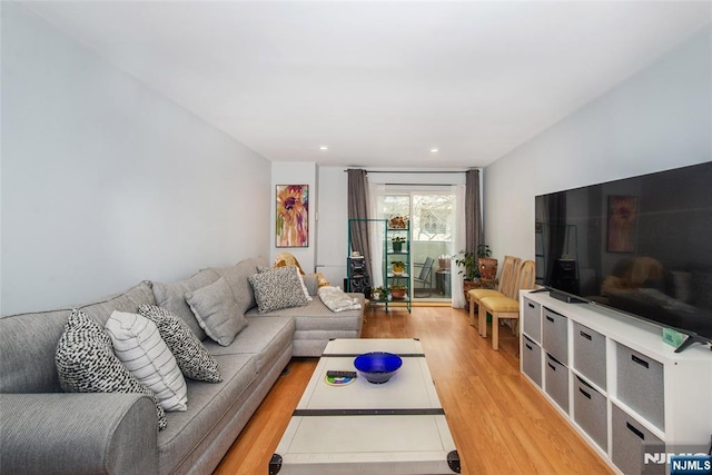 living area with recessed lighting and wood finished floors