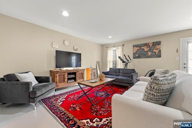 tiled living room featuring recessed lighting