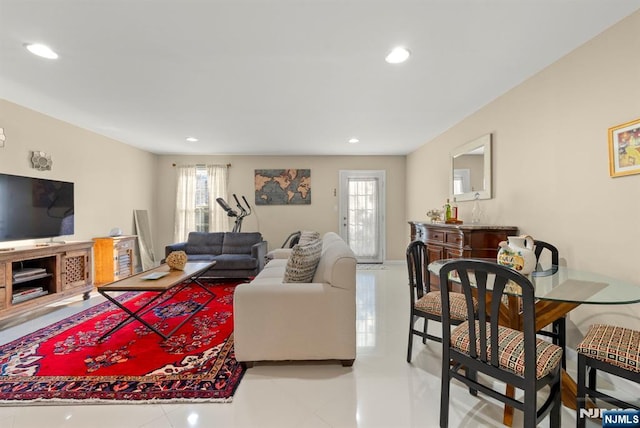 living room with a wealth of natural light, light tile patterned floors, and recessed lighting