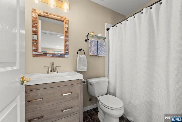 full bath featuring baseboards, toilet, vanity, and tile patterned flooring