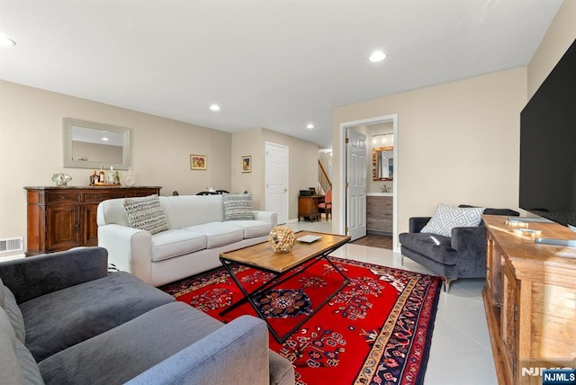 living room with light tile patterned floors, recessed lighting, and visible vents