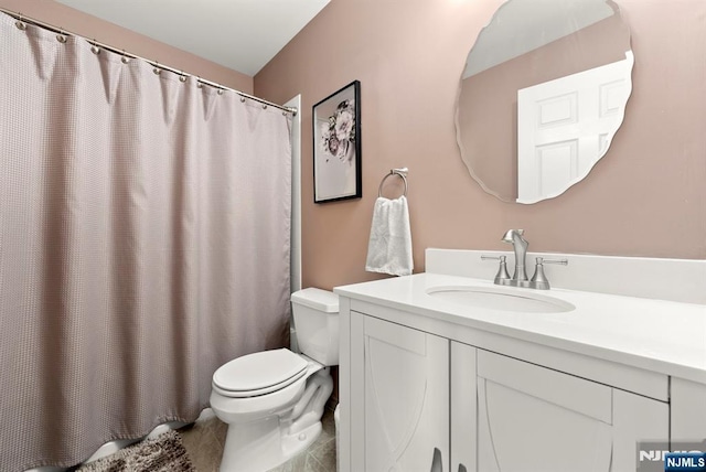 bathroom featuring vanity, a shower with shower curtain, and toilet