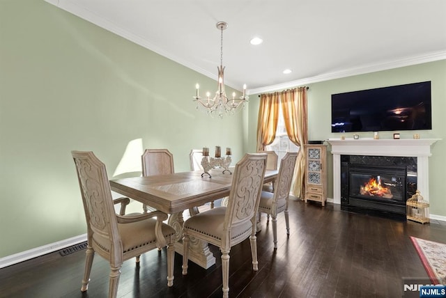 dining room with an inviting chandelier, crown molding, and wood-type flooring