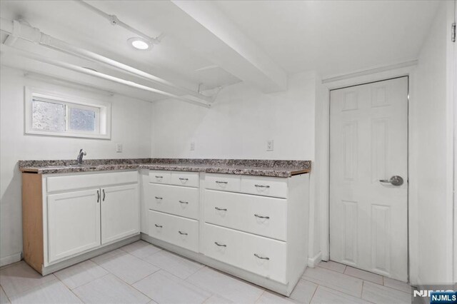 627 Montgomery, Elizabeth, NJ 07202 - kitchen featuring dark stone counters, white cabinets, light tile patterned flooring, and a sink