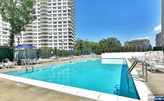 2077 Center Ave Unit 20F, Fort Lee, NJ 07024 - community pool featuring a patio and fence