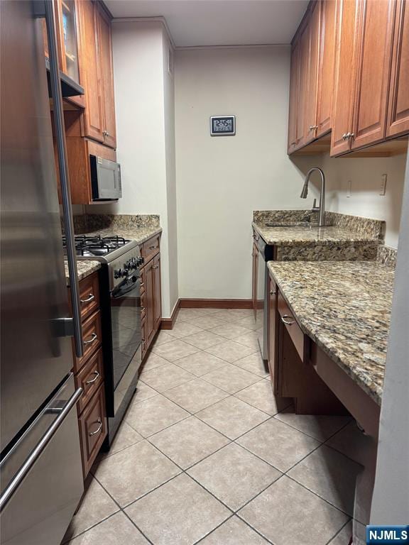 2077 Center Ave Unit 20F, Fort Lee, NJ 07024 - kitchen featuring light tile patterned flooring, light stone countertops, baseboards, and stainless steel appliances