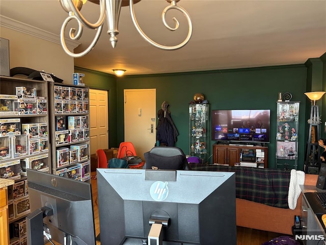 living area with wood finished floors and ornamental molding