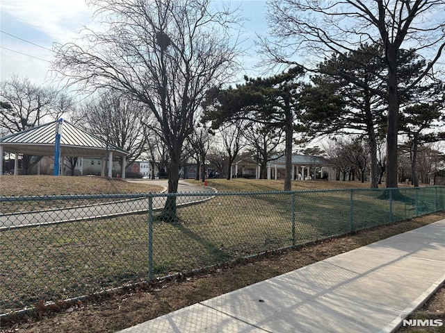 view of yard with a gazebo, concrete driveway, fence private yard, and a garage